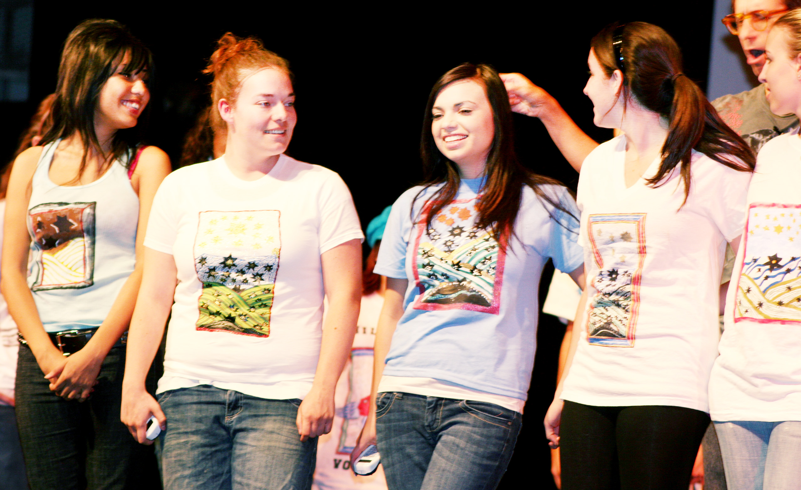 Students on stage in the CSULB University Theater wearing Hildegard von Bingen t-shirts of their own design