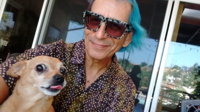 Tiki the chihuahua and Glenn the human sit on the patio in Monterey Park, Ca